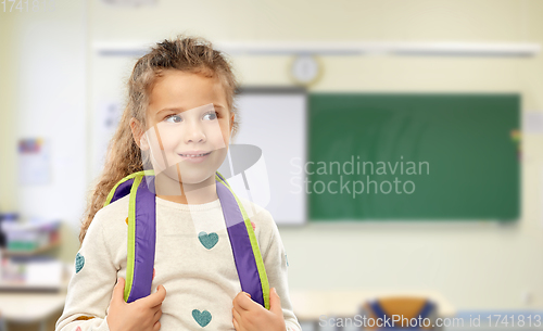 Image of happy little girl with backpack at school