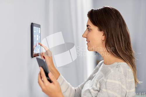 Image of woman using tablet computer and smartphone