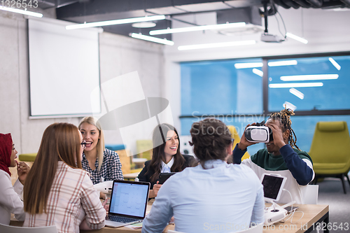 Image of Young Multiethnic Business team using virtual reality headset