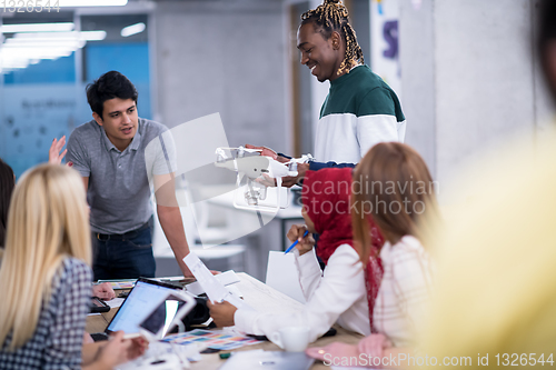 Image of multiethnic business team learning about drone technology