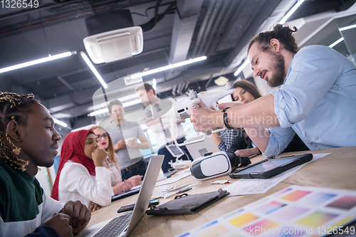 Image of multiethnic business team learning about drone technology