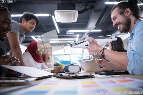 Image of multiethnic business team learning about drone technology