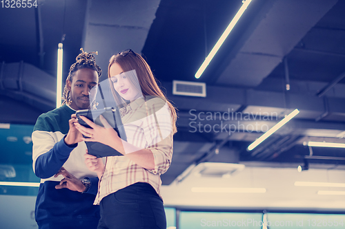 Image of multiethnic business couple using a tablet computer