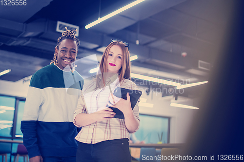 Image of multiethnic business couple using a tablet computer