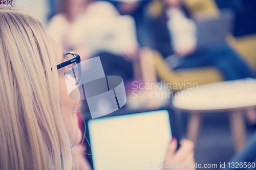Image of blonde businesswoman using digital tablet
