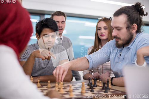 Image of multiethnic group of business people playing chess