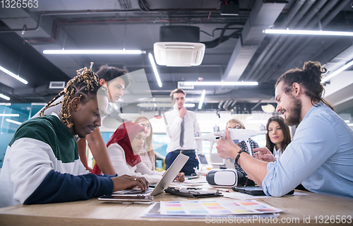 Image of multiethnic business team learning about drone technology