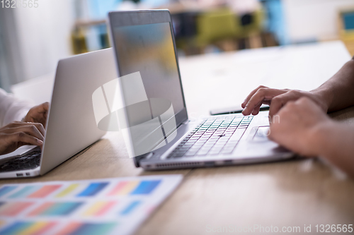 Image of black muslim business woman ,working on laptop computer