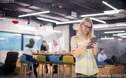 Image of blonde businesswoman working online using digital tablet