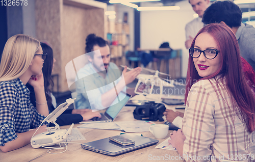 Image of redhead business woman learning about drone technology