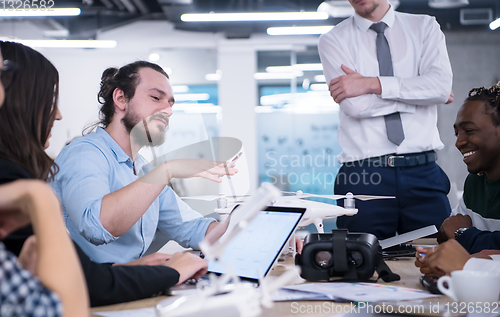 Image of multiethnic business team learning about drone technology