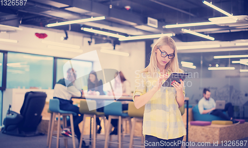 Image of blonde businesswoman working online using digital tablet