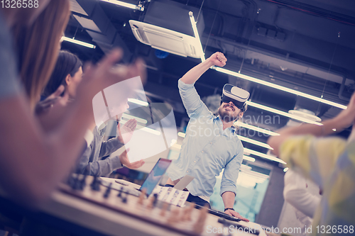 Image of Young Multiethnic Business team using virtual reality headset