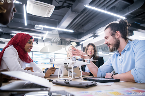 Image of multiethnic business team learning about drone technology