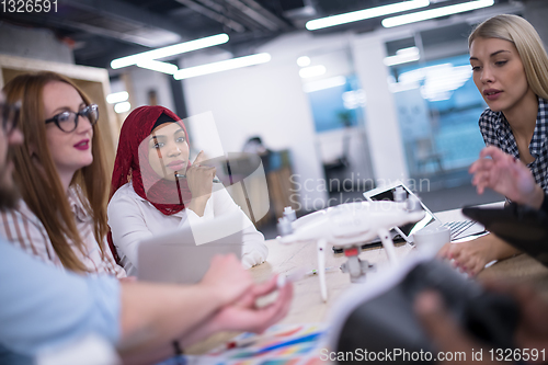 Image of multiethnic business team learning about drone technology