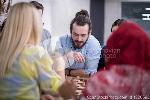 Image of multiethnic group of business people playing chess