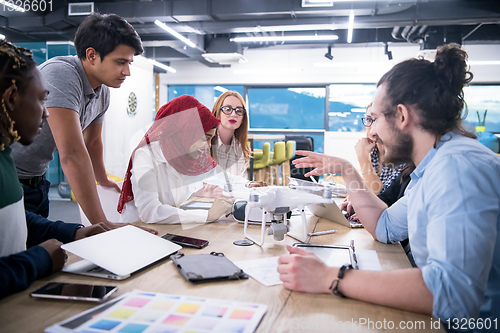 Image of multiethnic business team learning about drone technology