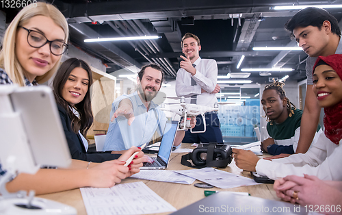 Image of multiethnic business team learning about drone technology