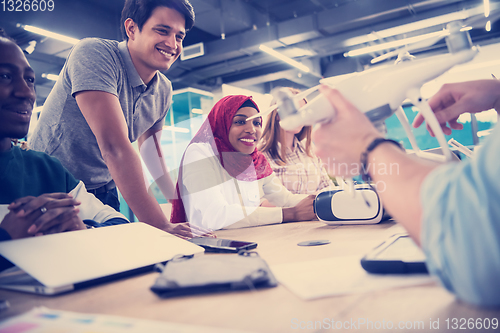 Image of multiethnic business team learning about drone technology