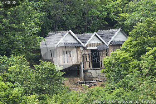 Image of Three old shacks in the forest