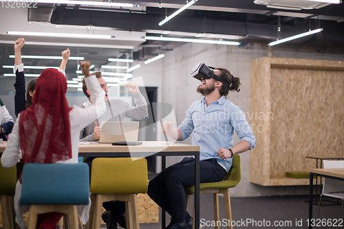 Image of Young Multiethnic Business team using virtual reality headset