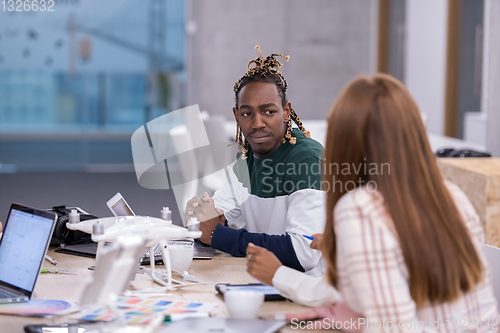 Image of multiethnic business team learning about drone technology