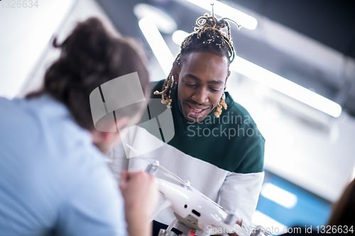 Image of multiethnic business team learning about drone technology