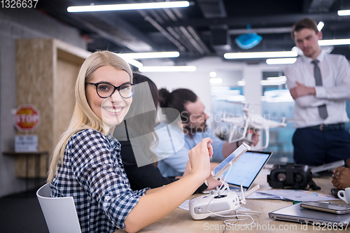 Image of blonde business woman learning about drone technology