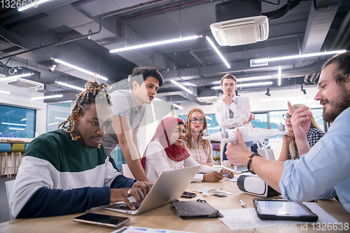 Image of multiethnic business team learning about drone technology