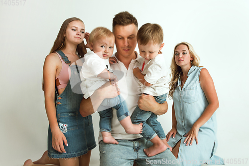 Image of Young family spending time together and smiling