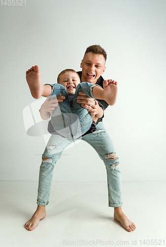Image of Happy father holding adorable little son and smiling