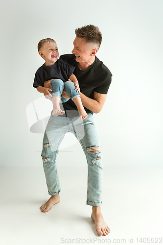 Image of Happy father holding adorable little son and smiling