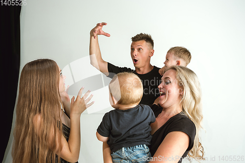 Image of Young family spending time together and smiling