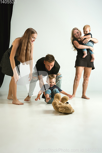 Image of Young family spending time together and smiling
