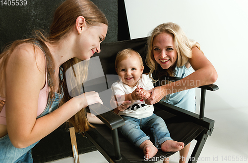 Image of Young family spending time together and smiling