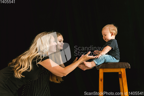 Image of Young family spending time together and smiling