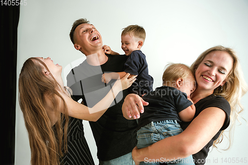 Image of Young family spending time together and smiling