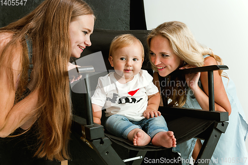 Image of Young family spending time together and smiling