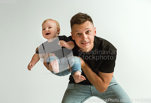 Image of Happy father holding adorable little son and smiling