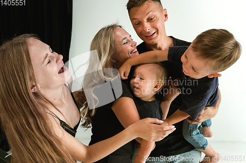 Image of Young family spending time together and smiling