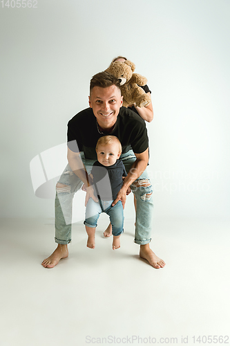 Image of Happy father holding adorable little son and smiling
