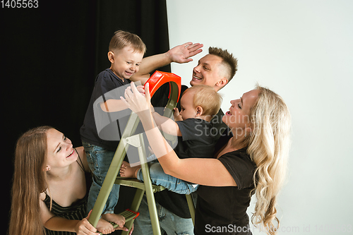 Image of Young family spending time together and smiling
