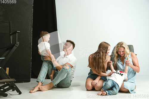 Image of Young family spending time together and smiling