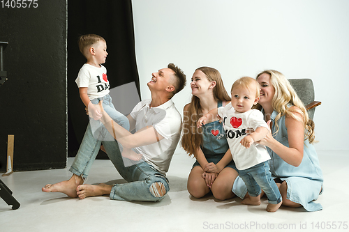 Image of Young family spending time together and smiling