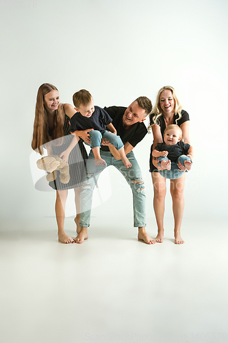 Image of Young family spending time together and smiling