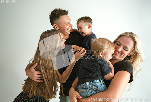 Image of Young family spending time together and smiling