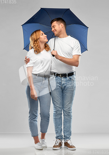 Image of happy couple in white t-shirts with umbrella