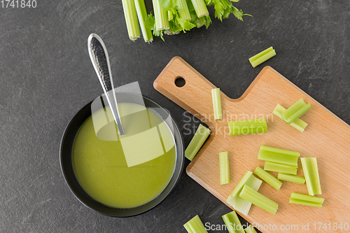 Image of celery cream soup in ceramic bowl with spoon