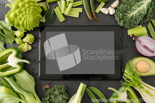 Image of green vegetables and tablet pc computer