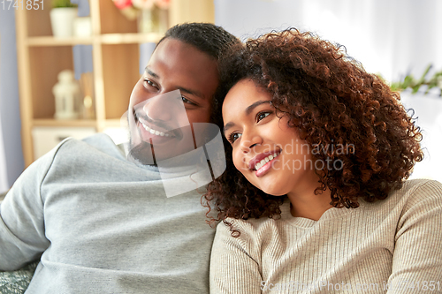 Image of happy african american couple hugging at home